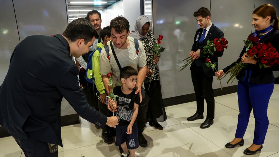 Turkish evacuees were welcomed with flowers at Istanbul Airport.