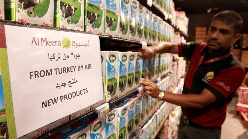 A worker places Turkish-made products on shelves in a supermarket in Doha. aa