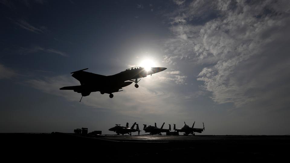 A US Navy fighter jet lands on the deck of the USS Dwight D Eisenhower aircraft carrier,  deployed in the Persian Gulf supporting military operations in Syria and Iraq.