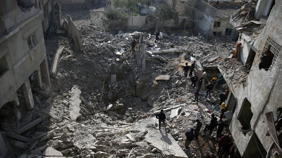 Men stand on the rubble of damaged buildings after an air strike in the Saqba area, in Damascus suburb of Eastern Ghouta, Syria, January 9, 2018.