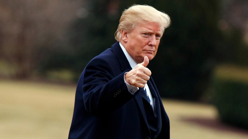 US President Donald Trump gives a thumbs up as he walks on the South Lawn of the White House after arriving aboard Marine One, on February 1, 2018, in Washington.