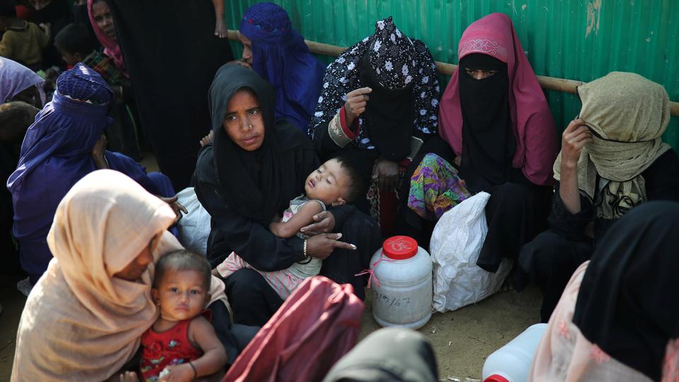 Rohingya refugee women wait outside of a medical center at Jamtoli camp in Cox's Bazar, Bangladesh on January 22, 2018