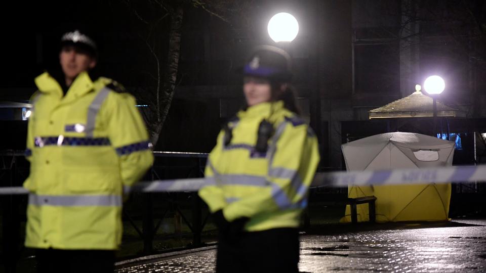 Police officers stand guard beside a cordoned-off area, after former Russian military intelligence officer Sergei Skripal, who was convicted in 2006 of spying for Britain, became critically ill after exposure to an unidentified substance, in Salisbury, southern England, March 5, 2018.