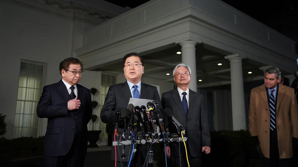 South Korean National Security Advisor Chung Eui-yong (C) briefs reporters outside the West Wing of the White House on March 8, 2018 in Washington, DC, announcing North Korean leader Kim Jong-un has offered to meet US President Donald Trump. At left is South Korea National Intelligence Service chief Suh Hoon.