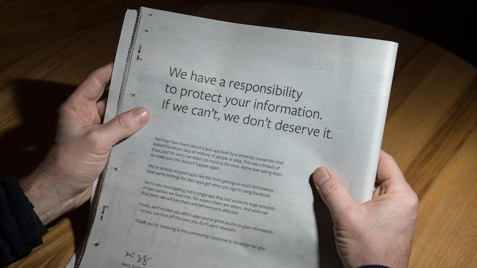 A man reads a full-page advertisement, taken out by Mark Zuckerberg, the chairman and chief executive officer of Facebook to apologise for the large-scale leak of personal data from the social network, on the back page of a newspaper, in Ripon, England on March 25, 2018.