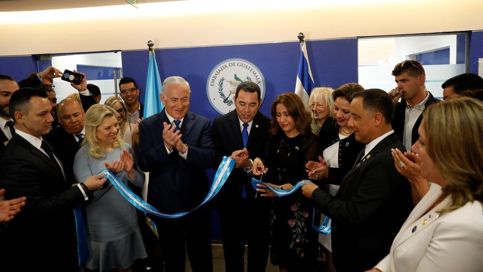 Hilda Patricia Marroquin, the wife of Guatemalan President Jimmy Morales, cuts the ribbon during the dedication ceremony of the embassy of Guatemala in Jerusalem, as she stands with Guatemalan President Jimmy Morales, Israeli Prime Minister Benjamin Netanyahu and his wife Sara, and Guatemalan Foreign Minister Sandra Jovel Polanco, May 16, 2018.