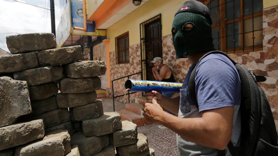 A demonstrator stands behind a barricade during protests in Monimbo neighbourhood in Masaya, some 40km from Managua on June 2, 2018.