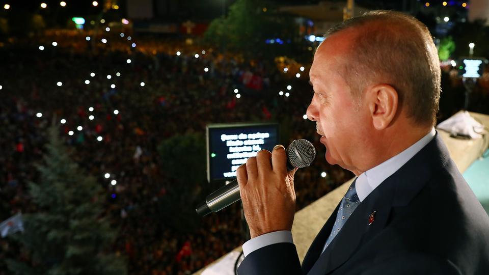 President of Turkey and leader of the Justice and Development Party (AK Party) Recep Tayyip Erdogan (R) greets the crowd from the balcony of the ruling AK Party's headquarters following his election success in presidential and parliamentary elections in Ankara, Turkey on June 25, 2018.