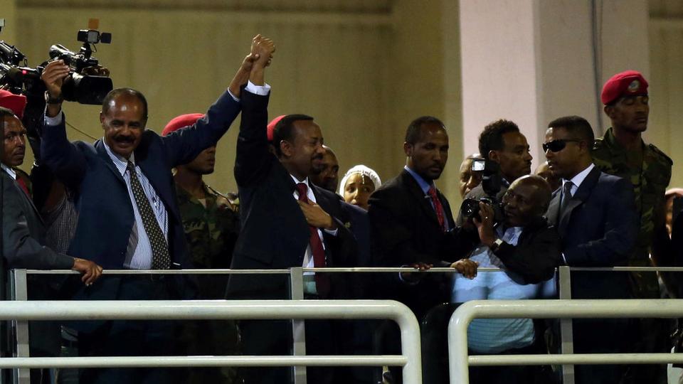 Eritrea's President Isaias Afwerki and Ethiopian Prime Minister Abiy Ahmed hold hands during a concert at the Millennium Hall in Addis Ababa, Ethiopia on July 15, 2018.