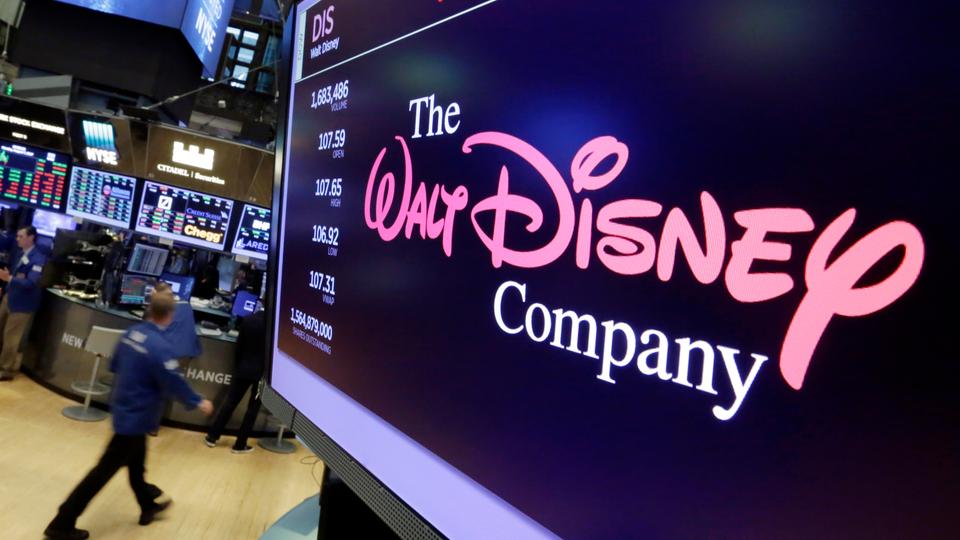 In this  August 7, 2017 photo, The Walt Disney Co. logo appears on a screen above the floor of the New York Stock Exchange.