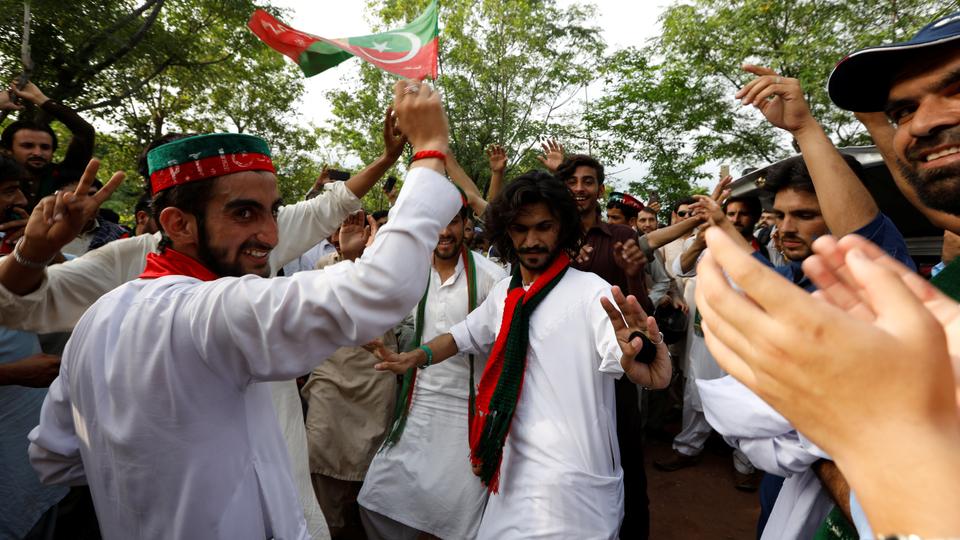 Supporters of cricket star-turned-politician Imran Khan, chairman of Pakistan Tehreek-e-Insaf (PTI), celebrate outside his residence in Islamabad, Pakistan, a day after polling in the general election, on July 26, 2018.