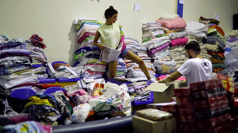 A volunteer arranges clothes for residents of areas that were struck by a wildfire in Nea Makri, near Athens, Greece, July 25, 2018.