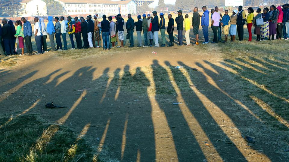 People wait in a queue to cast their vote at a polling station in Harare, Zimbabwe, Monday, July 30, 2018. Zimbabweans on Monday voted in their first election without Robert Mugabe on the ballot.