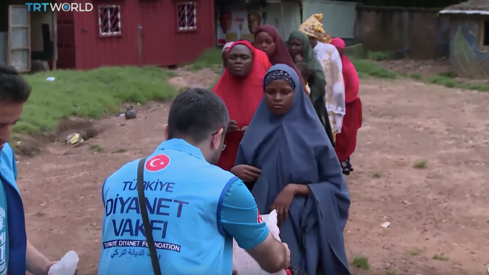 Aid agencies distribute a rare meal of meat in Durumi IDP camp in Abuja, Nigeria.