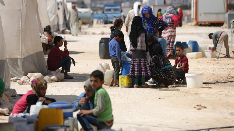 People who fled Syria's Idlib province are pictured at a camp in Kafr Lusin near the border with Turkey in the northern part of the province on September 9, 2018.