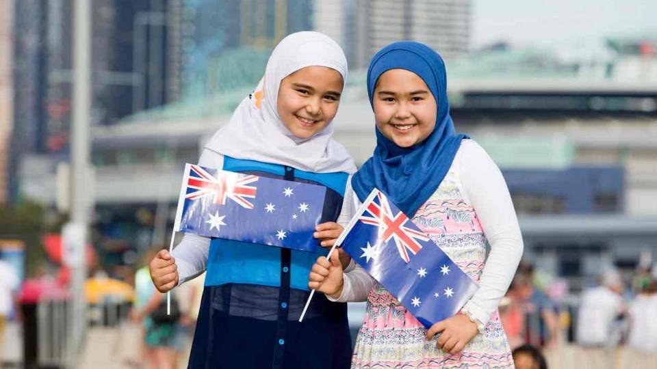 The photograph of the two girls wearing hijabs at an Australia Day event, w...