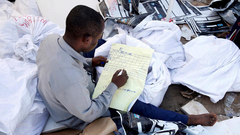 A man examines voting materials at Congo's Independent National Electoral Commission (CENI) tallying centre in Kinshasa, Democratic Republic of Congo, January 1, 2019.