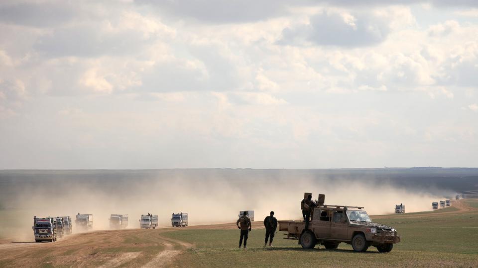 US-backed YPG militants stand near a pick-up truck near Baghouz, Deir Ezzor province, Syria. February 11, 2019.