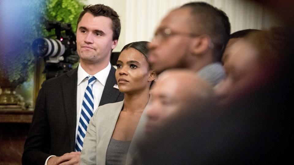 Candace Owens, center, listens as President Donald Trump speaks at the 2018 Young Black Leadership Summit in the East Room of the White House, Friday, Oct. 26, 2018, in Washington.
