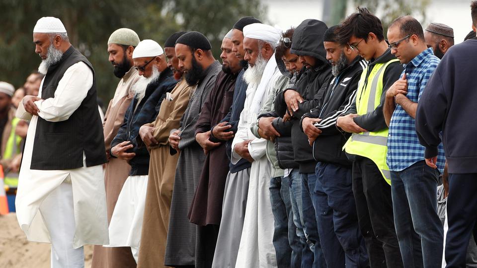 People pray during the burial ceremony of a victim of the mosque attacks, at the Memorial Park Cemetery in Christchurch, New Zealand March 21, 2019.