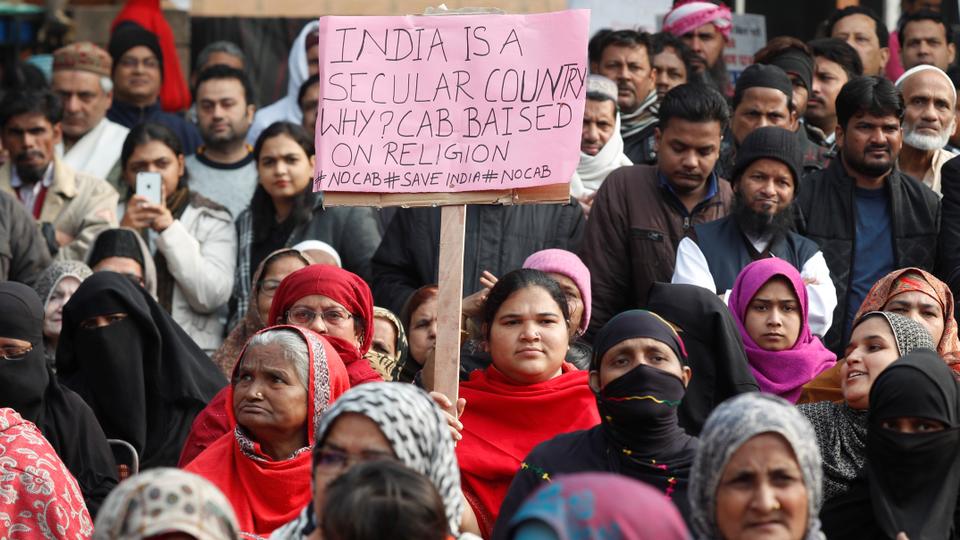 A demonstrator carries a sign during a protest against a new citizenship bill in New Delhi, India on December 22, 2019.