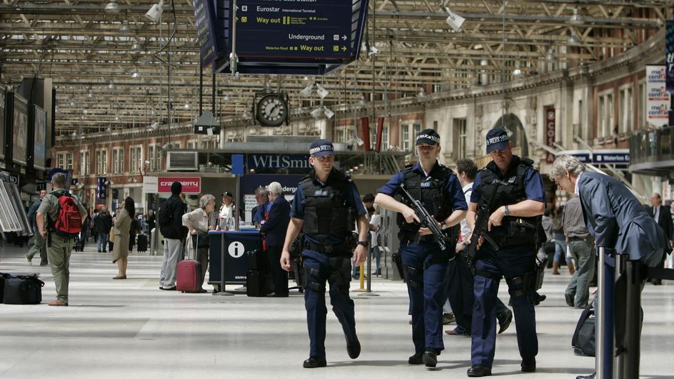 In this file photo, British police officers are seen patrolling Waterloo train station in central London on July 2, 2007.