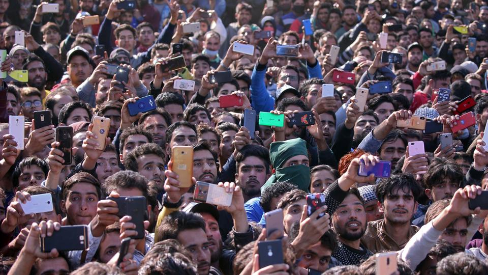 People use their mobile phones to take photographs during the funeral of Sabzar Ahmad Sofi, a suspected rebel, who according to local media was killed in a gun battle with Indian troops in south Kashmir's Sangam town on October 24, 2018.