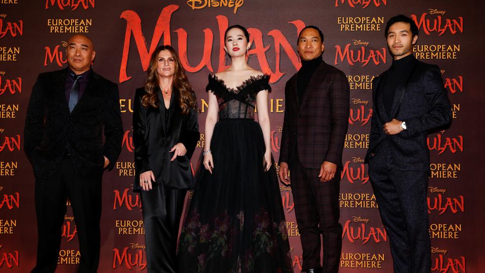 Cast members Ron Yuan, Yifei Liu, Jason Scott Lee and Yoson An pose with director Niki Caro, at the European premiere for the film 'Mulan'  in London, Britain March 12, 2020.