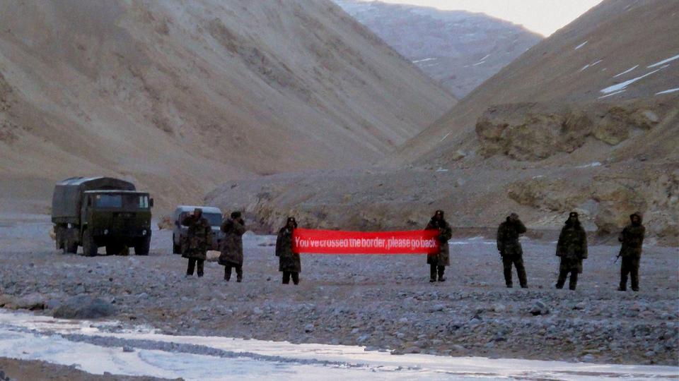 In this Sunday, May 5, 2013 file photo, Chinese troops hold a banner which reads 