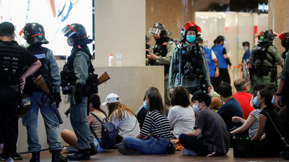 People detained by riot police officers are seen during a march against national security law in Hong Kong, China July 1, 2020.