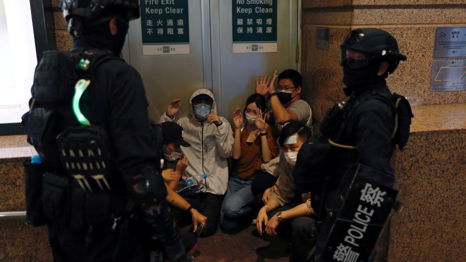 People detained by riot police during a march against national security law at the anniversary of Hong Kong's handover to China from Britain in Hong Kong, China July 1, 2020.