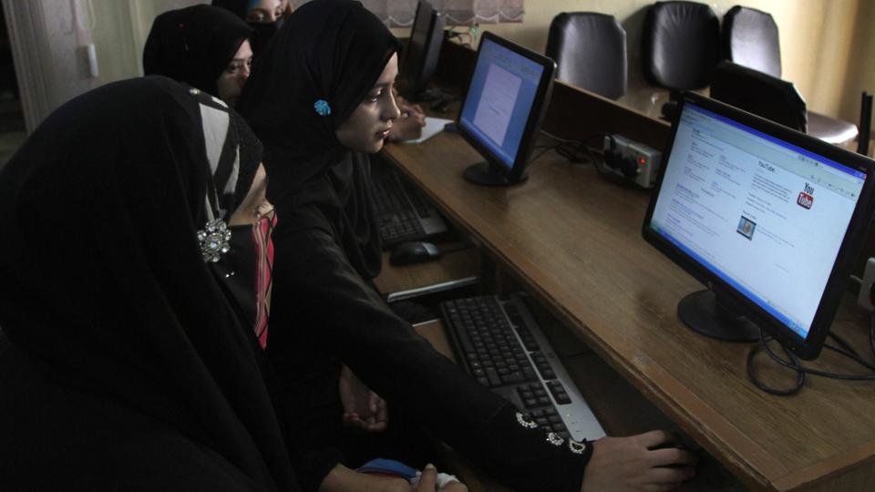 This file photo from September 5, 2013, shows Pakistani university students trying to access YouTube in Karachi amid a YouTube ban over the airing of an anti-Islamic film.