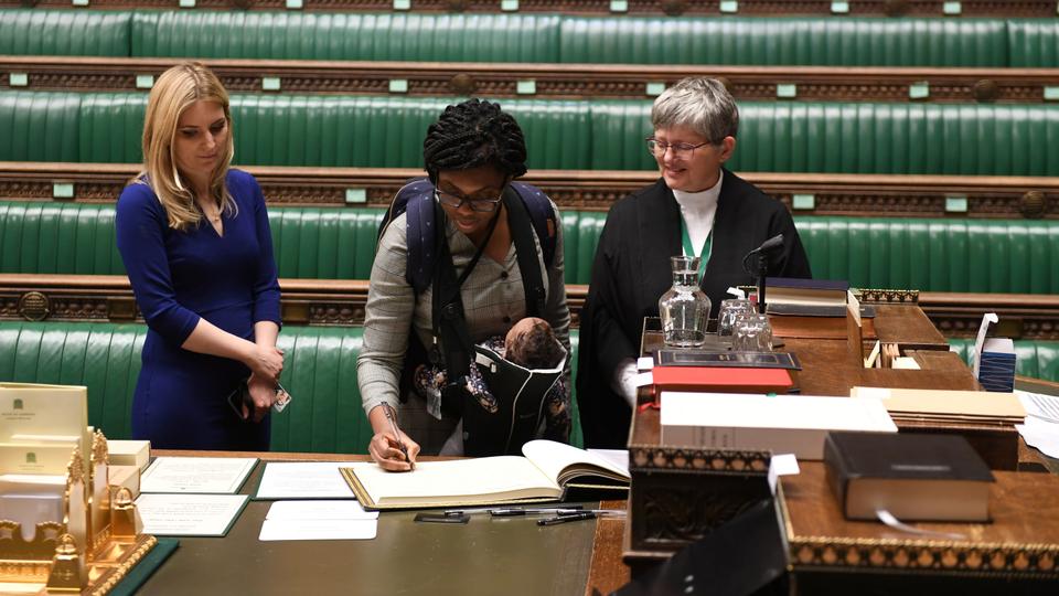 Britain's  Minister for Equalities, Kemi Badenoch, with her child attends a lawmakers meeting to elect a speaker and for a swearing-in ceremony, in London, Britain, December 17, 2019.