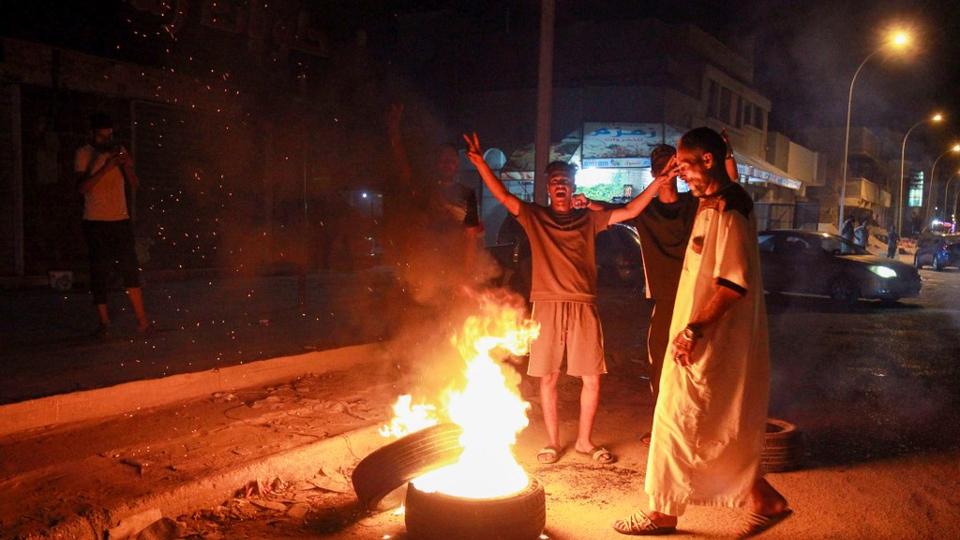 Libyan youth block a road with burning tyres in Libya's eastern coastal city of Benghazi on September 12, 2020, as they protest the poor public services and living conditions.