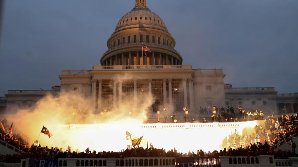An explosion caused by a police munition is seen while supporters of US President Donald Trump gather in front of the US Capitol Building in Washington, US, January 6, 2021.