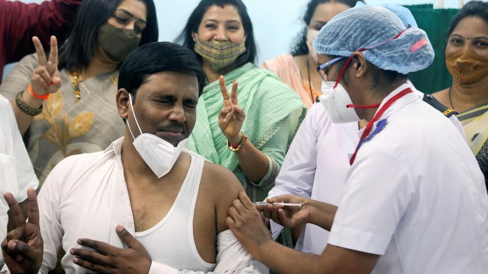 A healthcare worker reacts as he receives a jab during the Covid-19 vaccination campaign, at a medical centre in Mumbai, India on January 16, 2021.