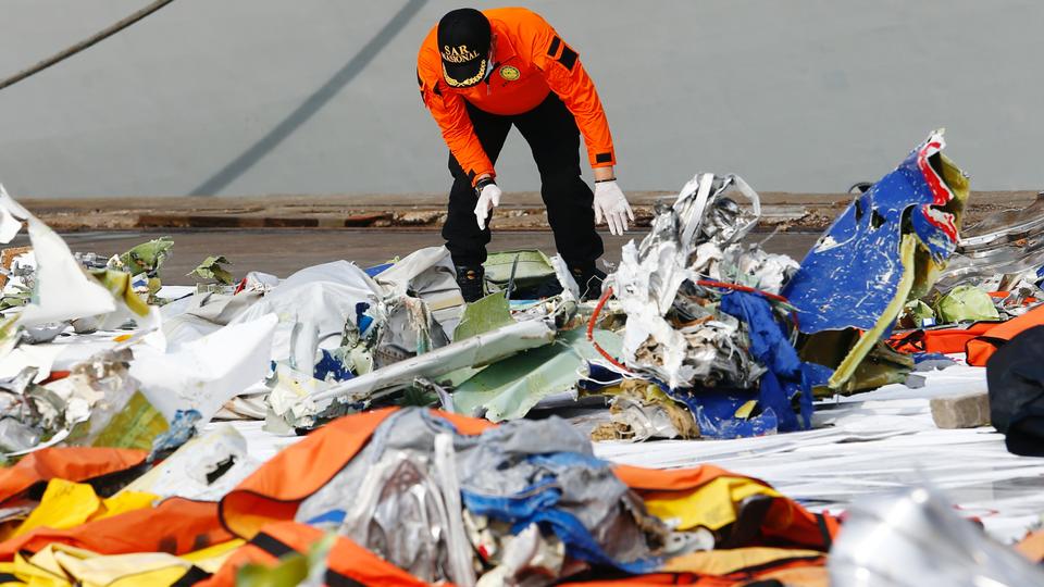 A member of Indonesia's rescue personnel observes the debris of Sriwijaya Air flight SJ 182 in Jakarta, Indonesia, January 21, 2021.