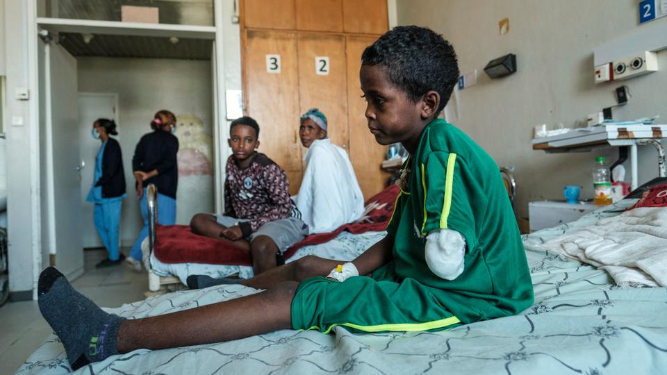 Fisseha Abraha, 8-years-old, sits on his bed at the Ayder Referral Hospital in the Tigray capital Mekele on February 25, 2021, after being injured during fighting between the Tigray People's Liberation Front which fell after Ethiopian Prime Minister deployed troops and warplanes to oust the TPLF late last year