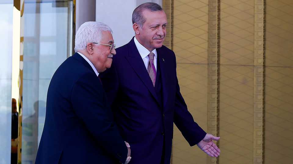 Turkish President Recep Tayyip Erdogan and Palestinian President Mahmoud Abbas shake hands as they pose for a photo during an official welcoming ceremony at the Presidential Complex in Ankara, Turkey on August 28, 2017.
