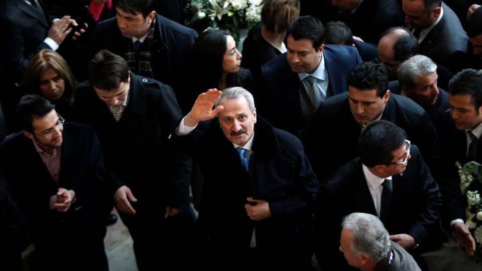 Turkeys outgoing Economy Minister Zafer Caglayan waves as he arrives at a handover ceremony in Ankara, December 26, 2013. 