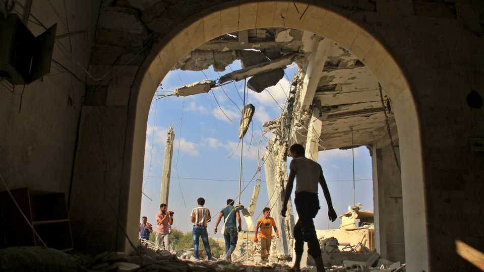 Syrians check the damage in a mosque following a reported air strike on the village of Jarjanaz, in the Maaret al-Numan district of Syrias Idlib province, on September 20, 2017.