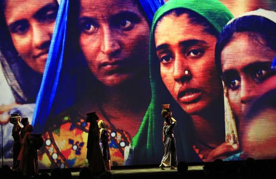 Backdropped by a projected picture of refugees, actors perform during the opening ceremony of the World Humanitarian Summit, in Istanbul, Monday, May 23, 2016.