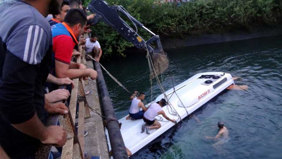 Civilians try to rescue people from a bus carrying primary school students, teachers and parents, which toppled into an irrigation channel in Osmaniye, Turkey on June 5, 2016.