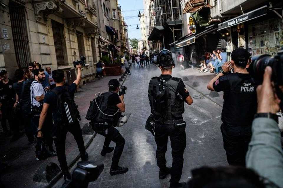 Turkish anti-riot police officers disperse demonstrators gathered for a rally staged by the LGBT community on Istiklal avenue in Istanbul on June 19, 2016.