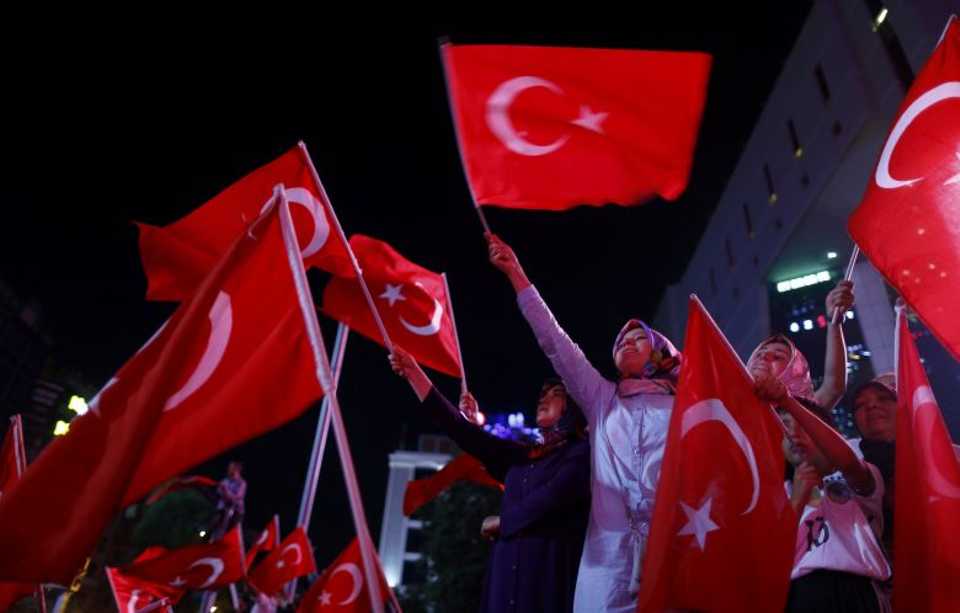 Supporters of Turkish President Tayyip Erdogan wave Turkish flags during a demonstration outside parliament building in Ankara, Turkey, July 16, 2016.