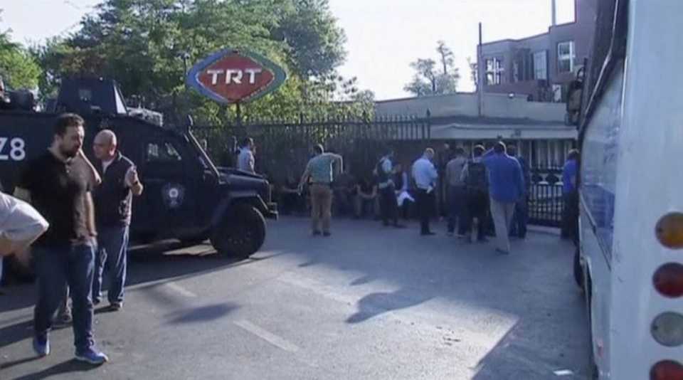 A still image from video shows armoured police vehicle and people waiting outside TRT state television after a failed coup attempt by a group of Turkish soldiers, in Istanbul, Turkey July 16, 2016. 