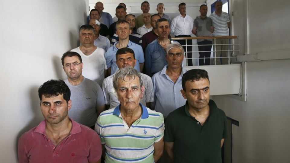 Prime suspect behind failed coup attempt, retired Turkish Air Forces Commander Akin Ozturk - pictured standing in the front row in the centre - along with other arrested suspects