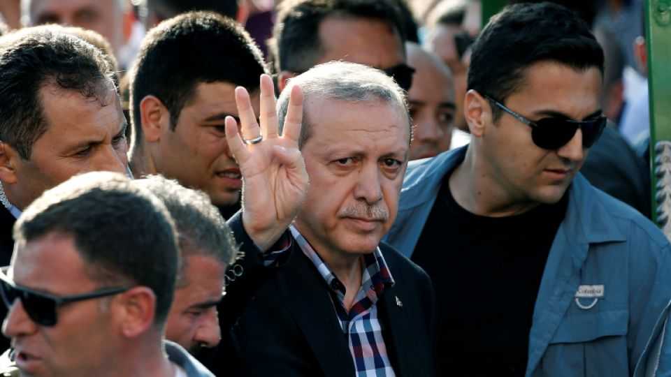 Turkish President Recep Tayyip Erdogan waves to the crowd following a funeral service for a victim of the thwarted coup in Istanbul, Turkey, July 17, 2016. 