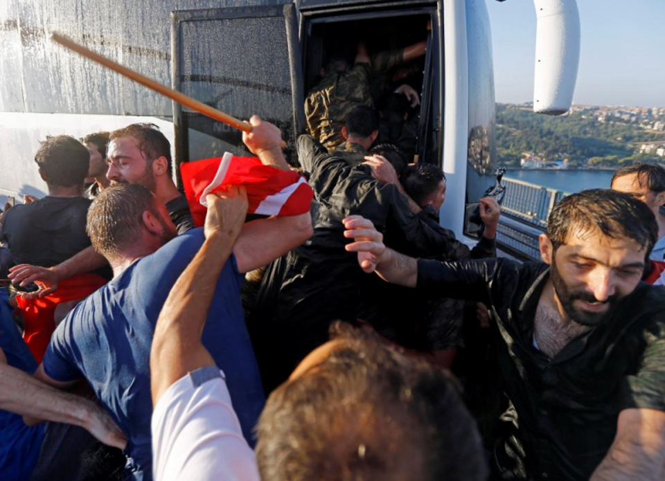Soldiers involved in the coup attempt push each other onboard a bus to escape the mob after surrendering on the Bosphorus Bridge in Istanbul, Turkey July 16, 2016.