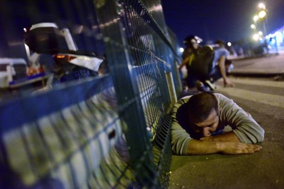 People take cover near a bridge during the attempted coup in Istanbul, Turkey.